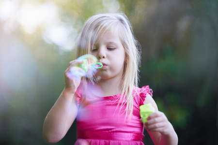 Filling summer with some fun times. Cropped shot of a cute little girl playing outside.の写真素材