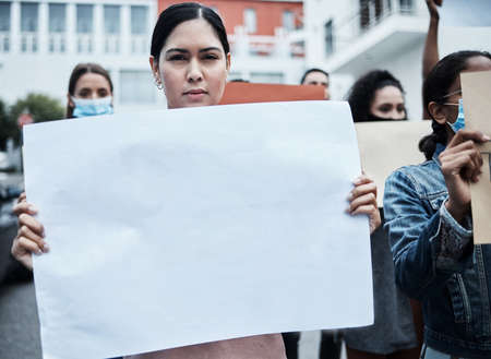 I stand by my beliefs. Shot of a young woman protesting at a covid vaccine march.の写真素材