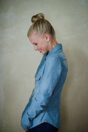 Hipster style. Studio shot of a young woman wearing a demin shirt.の写真素材