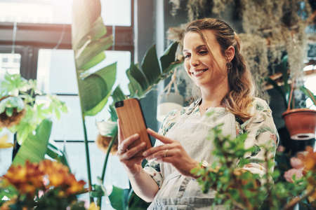 I take fresh pictures of my flowers every day. Cropped shot of an attractive young businesswoman...