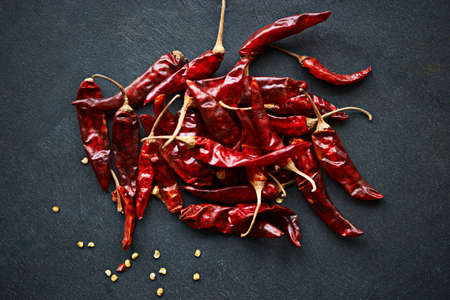 Increase the heat. High angle shot of dried red chillies on a kitchen counter.