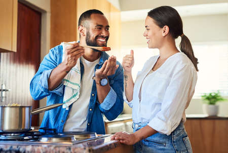Does it taste good. Shot of a couple cooking together at home.