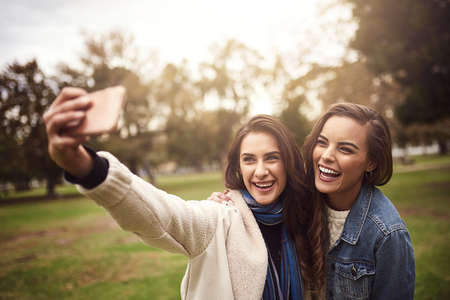 We love taking selfies together. Shot of two cheerful young friends taking a self portrait together...