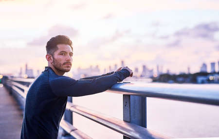Today Im going to train even harder. Shot of a sporty young man taking a break while exercising...