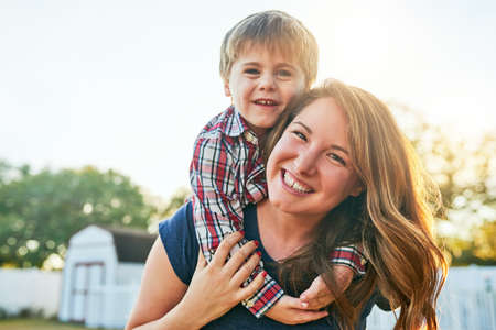 Its about making those fun time memories. Portrait of a mother giving her adorable little son a...