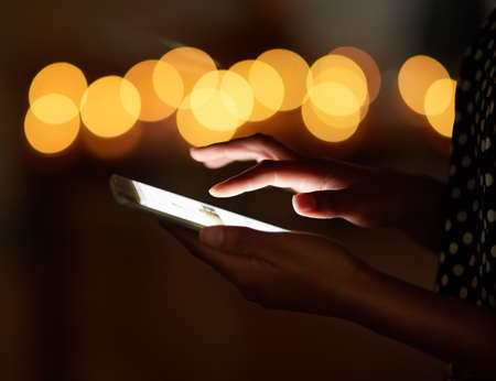 Theres no reason to lose contact.... Cropped shot of an unrecognizable person using a cellphone.の写真素材