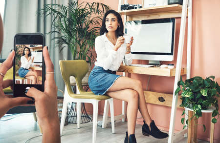 I have a few tips for success. Shot of a blogger having her picture taken on a smartphone.