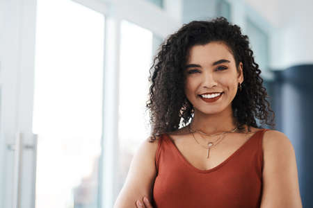 I love my job. Cropped portrait of an attractive young businesswoman standing alone in her office...