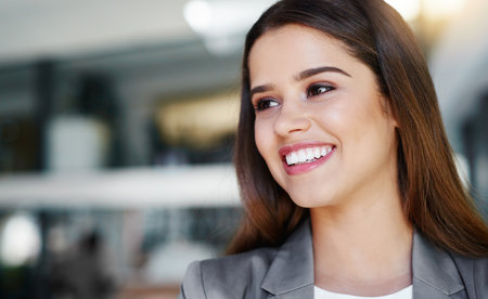 Young and inspired. Cropped shot of an attractive young businesswoman in the office.の写真素材
