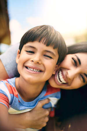All we need is us. Closeup portrait of an attractive young woman and her young son outside.の写真素材