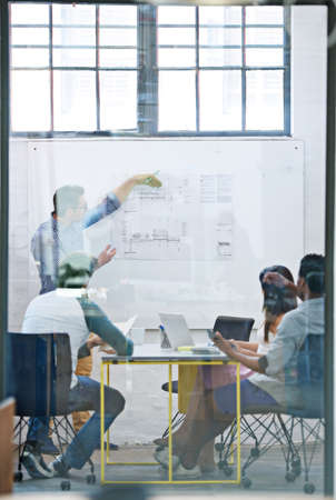 This here makes for the best possible flow. Cropped shot of a group of architects discussing plans.の写真素材