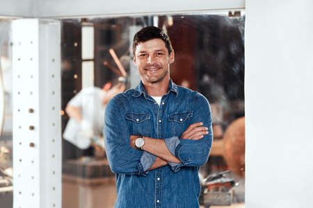 I turned my passion into a successful business. Portrait of a handsome young businessman posing in...