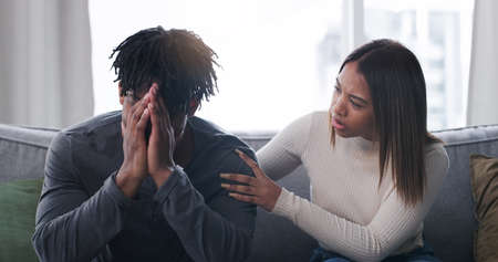 Tell me whats wrong. Shot of a young couple having an argument at home.の写真素材