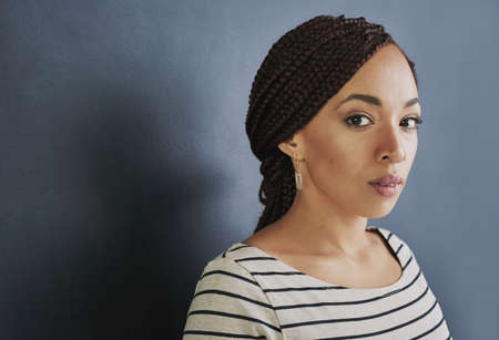 If you want it, work for it. Studio shot of a young woman standing against a dark background.