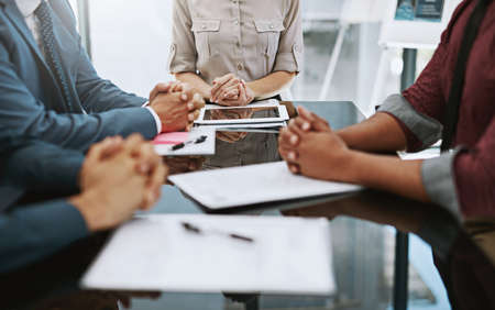 Ready for the meeting. Cropped shot of a group of businesspeople in the boardroom.の写真素材