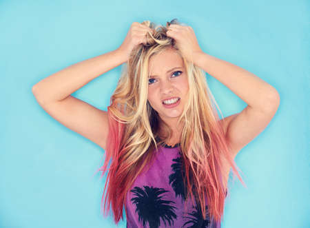 Thats so frustrating. A trendy young woman pulling her hair in frustration.