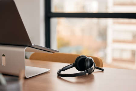 Communication is vital to success. Still life shot of a wireless headset on a desk in a call center.