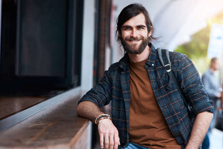 I hope everyone is enjoying their day too. Portrait of a handsome young man posing outside a cafe in...