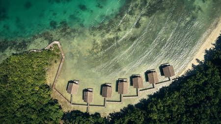 Your once in a lifetime experience is waiting for you. High angle shot of bungalows along the island coasts of Indonesia.の写真素材