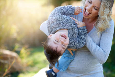 Having some fun with mommy. Cropped shot of a mother bonding with her little boy outside.の写真素材