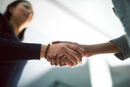 Shaking on their success. Cropped shot of two creative businesspeople shaking hands.の写真素材
