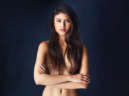 Theres something sexy about confidence. Cropped portrait of a gorgeous young woman posing against a...