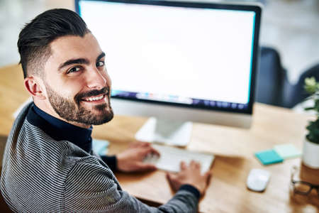 Hard work is no stranger to me. Portrait of a confident young designer working in an office.