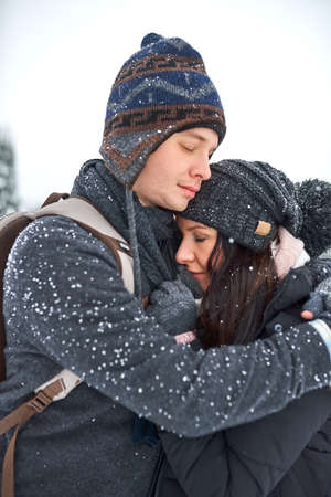 Ill keep you warm. Shot of a happy young couple enjoying themselves while being out in the snow.