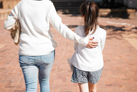Grandma will always give her the best guidance. Rearview shot of a little girl walking with her grandmother in a outdoors.の写真素材