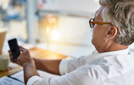 I think this flu is affecting my eyesight. Shot of a mature businessman struggling to use his...