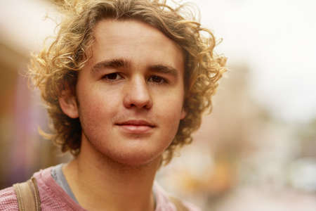 Hes one laid back dude. Portrait of a young man standing in a city street.