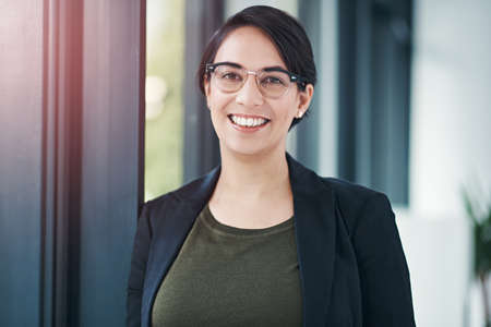 Im content in the corporate world. Portrait of a successful businesswoman standing in her office.