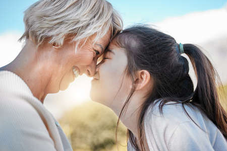 Together is such a blessing. Shot of a little girl bonding with her grandmother outdoors.の写真素材