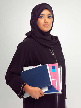 Not just a pretty face. Cropped shot of a young muslim woman holding stationary.