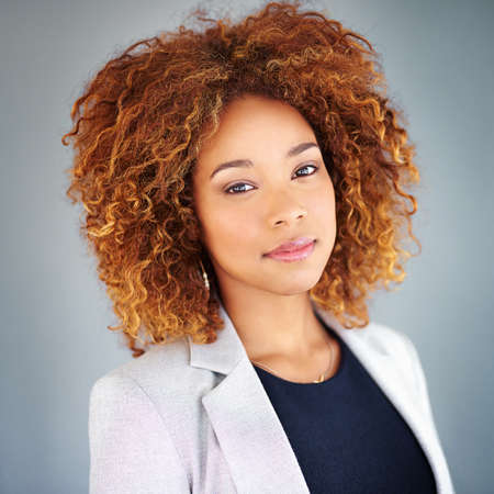 Hard work comes before success. Studio portrait of a young businesswoman against a gray background.