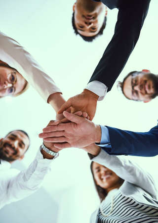 Staying motivated in their quest for success. Low angle shot of a diverse group of businesspeople...