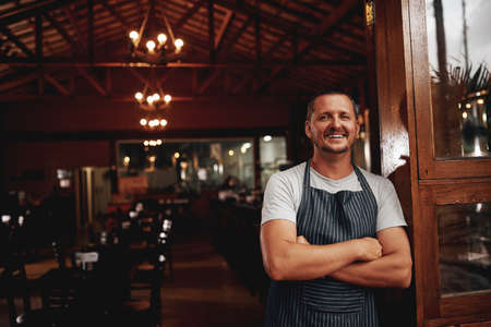 The master taking a break. Portrait of a confident middle aged business owner standing with arms...