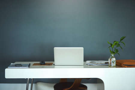 The modern way to work. Shot of a laptop on a desk in a creative business space.の写真素材