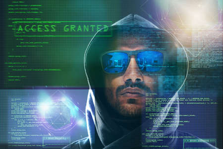 I laugh at your puny firewall. Portrait of a menacing computer hacker posing against a dark...