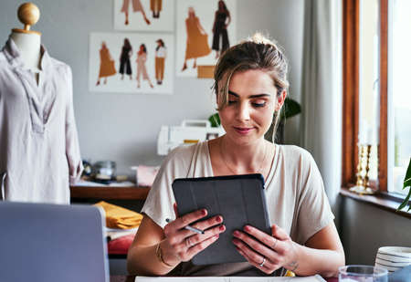 Im happy with all the reviews I got on my designs. Cropped shot of a fashion designer using a...