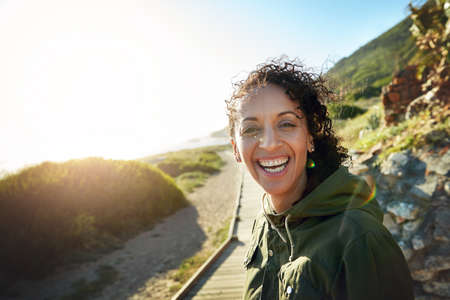 Breathing in fresh air is good for you. Shot of a woman out for her morning walk.