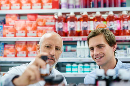 We only recommend the best to you. Shot of a pharmacist assisting a customer in a chemist.の写真素材