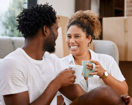 The prospect of going home is very appealing. Shot of a couple drinking coffee in their new home.