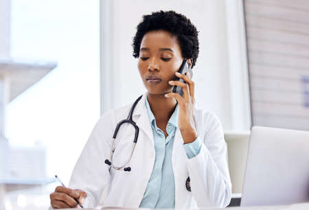 I would suggest you make an appointment. Cropped shot of an attractive young female doctor taking notes while making a phonecall in her office.の写真素材