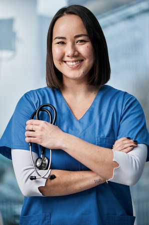 She embodies medical professionalism. Portrait of a medical practitioner standing in a hospital.の写真素材