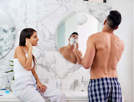 Freshening up for the day ahead. Shot of a young couple going through their morning routine together...