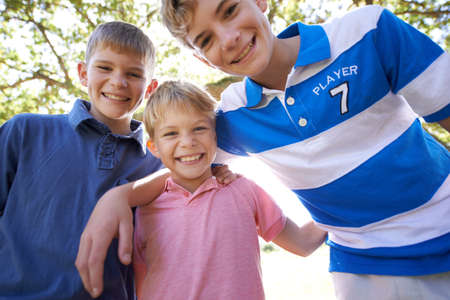 Having a great time together. Portrait of three young brothers enjoying a day outside.