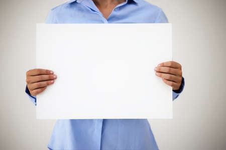 So this happened.... Studio shot of an unrecognisable businesswoman holding up a blank sign against...