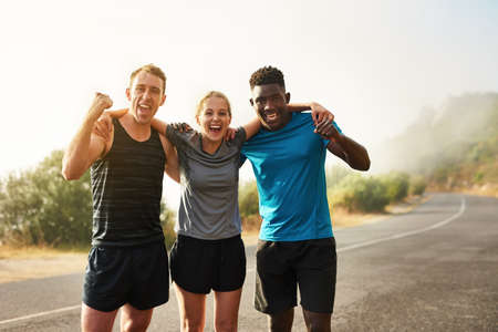 Only those who persevere will become victorious. Portrait of a group of sporty young people...
