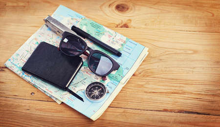 I havent been everywhere, but its on my list. High angle shot of sunglasses, a notebook, a compass...
